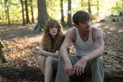 Costume design by Anette Cseri for the film Burden: a couple sitting together on the ground in autumn woods