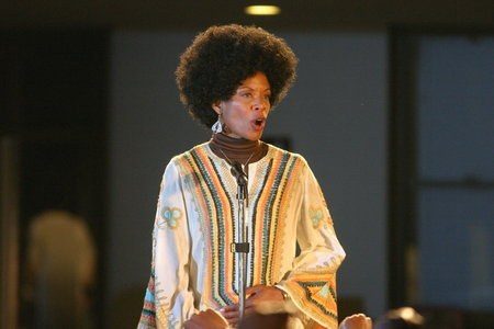 Costume design by Anette Cseri for the film Sarang Song: a woman singing in a patterned early 1970s kaftan