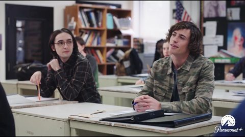 Costume design by Anette Cseri for the film The In Between: two teenage boys at classroom desks, one in a camouflage jacket