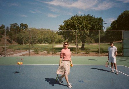 Costume design by Anette Cseri for the film The Tribes of Palos Verdes: a woman walking off a tennis court in a pleated skirt
